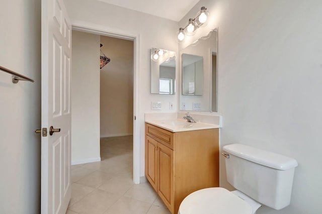 bathroom featuring vanity, tile patterned floors, and toilet