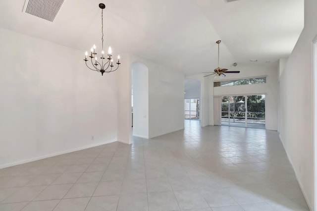 empty room with arched walkways, ceiling fan with notable chandelier, visible vents, baseboards, and vaulted ceiling