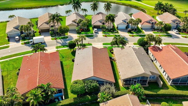 drone / aerial view featuring a water view and a residential view