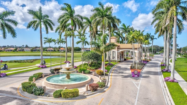 surrounding community featuring a water view and a yard