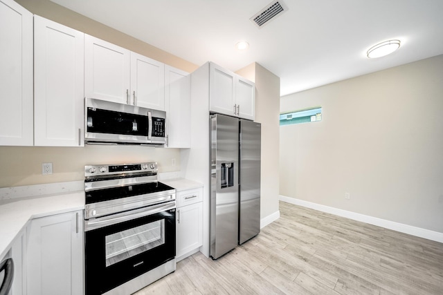 kitchen with white cabinetry, appliances with stainless steel finishes, and light wood-type flooring