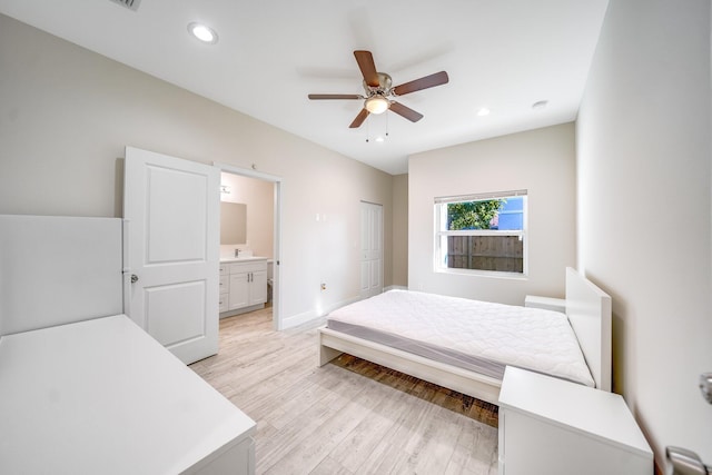 bedroom featuring ceiling fan, connected bathroom, and light wood-type flooring