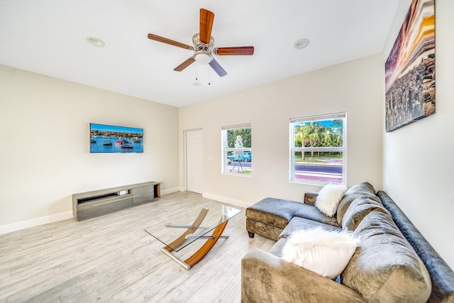 living room featuring ceiling fan and light hardwood / wood-style floors