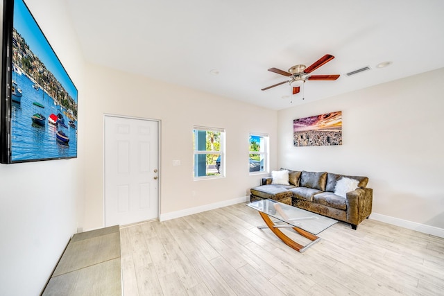 living room with light hardwood / wood-style floors and ceiling fan