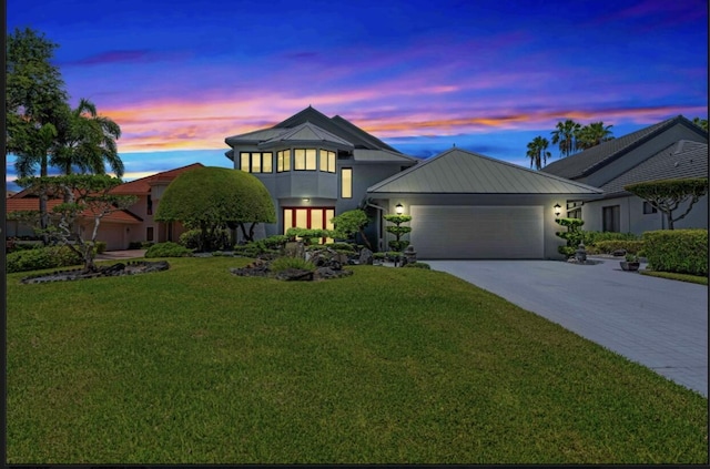 view of front facade with a garage and a yard