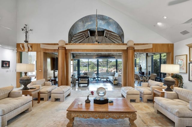 living room with plenty of natural light and high vaulted ceiling