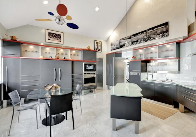 kitchen featuring sink, gray cabinetry, high vaulted ceiling, a center island, and black appliances