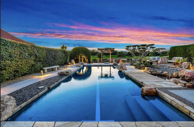 view of pool at dusk