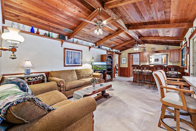 tiled living room with wood ceiling, ceiling fan, wood walls, and vaulted ceiling with beams