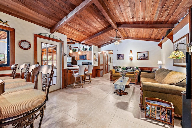 tiled living room with vaulted ceiling with beams, ceiling fan, and wooden ceiling