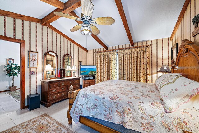 bedroom with lofted ceiling with beams, light tile patterned floors, and ceiling fan