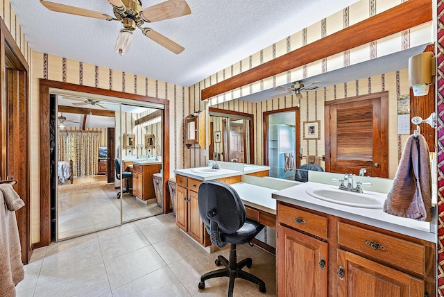 bathroom featuring vanity, ceiling fan, tile patterned floors, and a textured ceiling