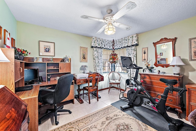 home office featuring ceiling fan, a textured ceiling, and light tile patterned floors