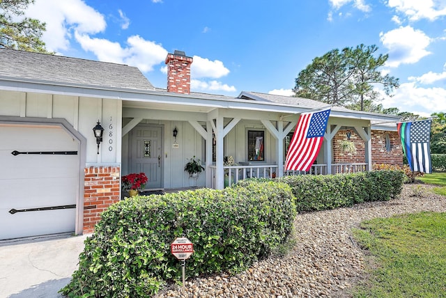 view of front of home with a porch and a garage