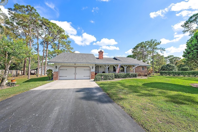 single story home with a garage, a front yard, and covered porch