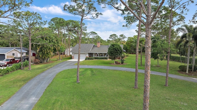 view of front of home featuring a garage and a front yard