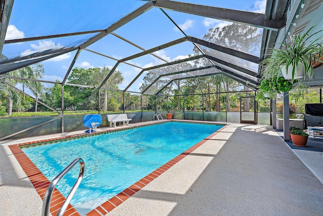 view of pool featuring a patio and glass enclosure