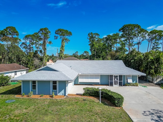 ranch-style home with a garage and a front yard