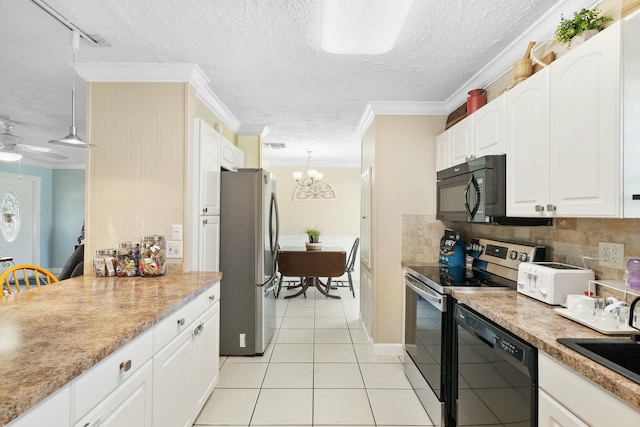 kitchen with hanging light fixtures, ornamental molding, black appliances, and white cabinets