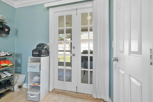 doorway featuring ornamental molding and light wood-type flooring