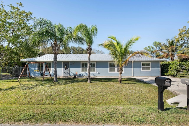 3261 SE Hibiscus St, Stuart, FL 34997 - view of front facade with a front lawn and metal roof