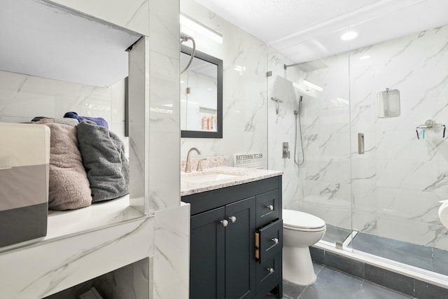 bathroom with vanity, toilet, an enclosed shower, and tile walls