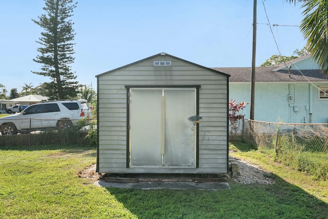 view of outdoor structure with a lawn