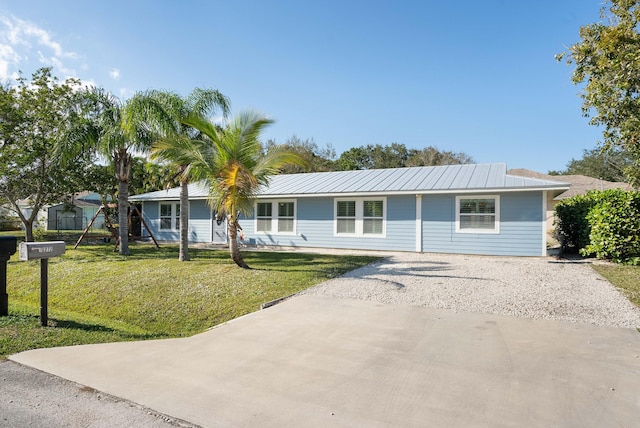 3261 SE Hibiscus St, Stuart, FL 34997 - single story home with a front lawn, driveway, and metal roof