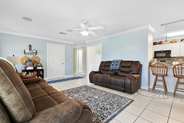 living room with light tile patterned floors, crown molding, rail lighting, ceiling fan, and a textured ceiling