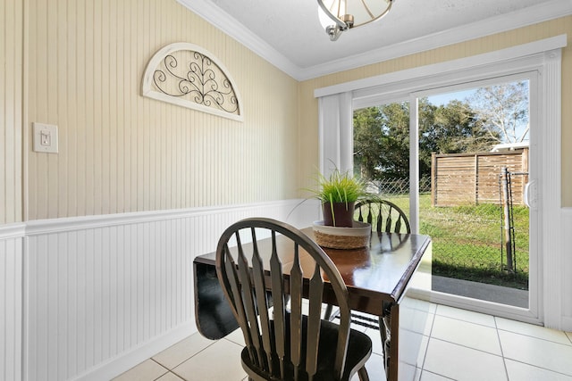 dining area featuring crown molding, a textured ceiling, and light tile patterned floors