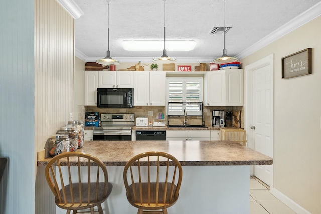 kitchen featuring sink, crown molding, black appliances, hanging light fixtures, and white cabinets