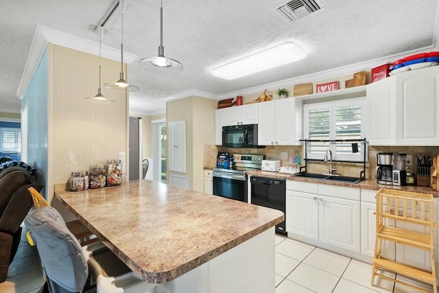 kitchen with black appliances, sink, white cabinets, hanging light fixtures, and kitchen peninsula