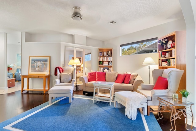 living room with hardwood / wood-style floors and a textured ceiling