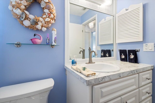 bathroom with vanity and toilet