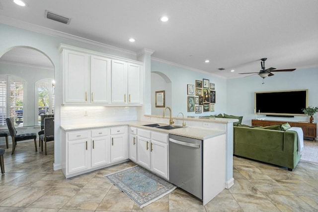 kitchen with sink, tasteful backsplash, white cabinets, stainless steel dishwasher, and kitchen peninsula