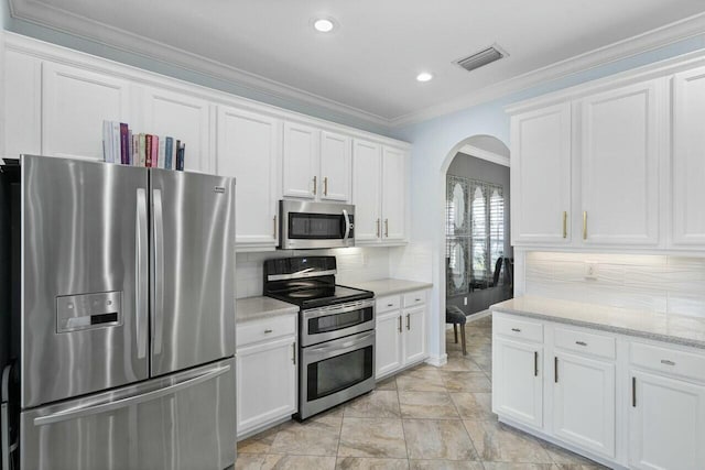 8877 Kettle Drum Ter, Boynton Beach, FL 33473 - kitchen with stainless steel appliances, white cabinets, crown molding, visible vents, and arched walkways