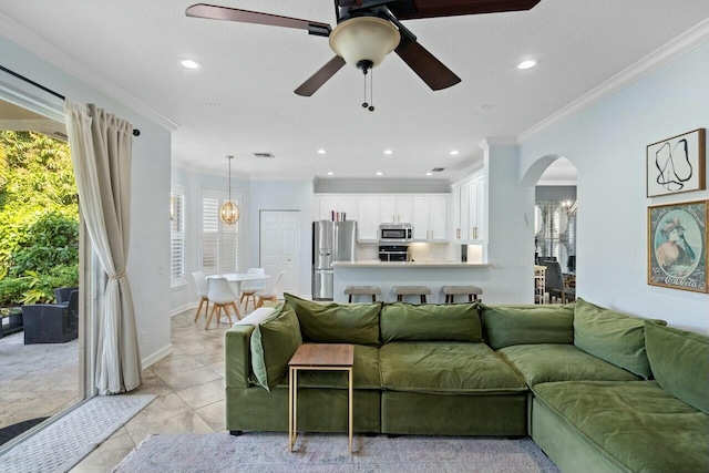 8877 Kettle Drum Ter, Boynton Beach, FL 33473 - living room featuring a ceiling fan, recessed lighting, baseboards, crown molding, and arched walkways
