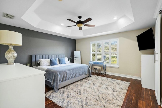 8877 Kettle Drum Ter, Boynton Beach, FL 33473 - bedroom featuring visible vents, dark wood-style flooring, a ceiling fan, a tray ceiling, and baseboards