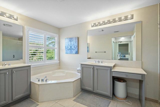 bathroom featuring a sink, two vanities, a stall shower, and a bath