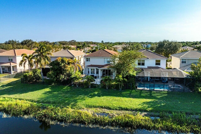 back of house with a fenced in pool, fence, a residential view, glass enclosure, and a yard