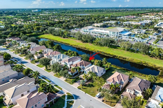 drone / aerial view with a residential view and a water view