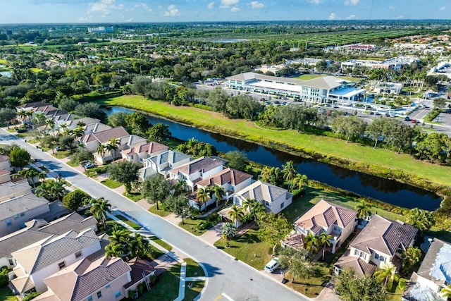 drone / aerial view featuring a residential view and a water view