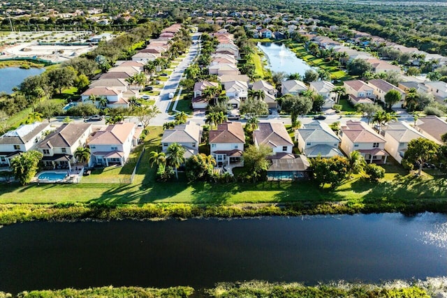 drone / aerial view featuring a residential view and a water view