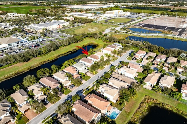 drone / aerial view featuring a residential view and a water view