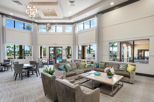 carpeted living room with an inviting chandelier, french doors, visible vents, and a tray ceiling