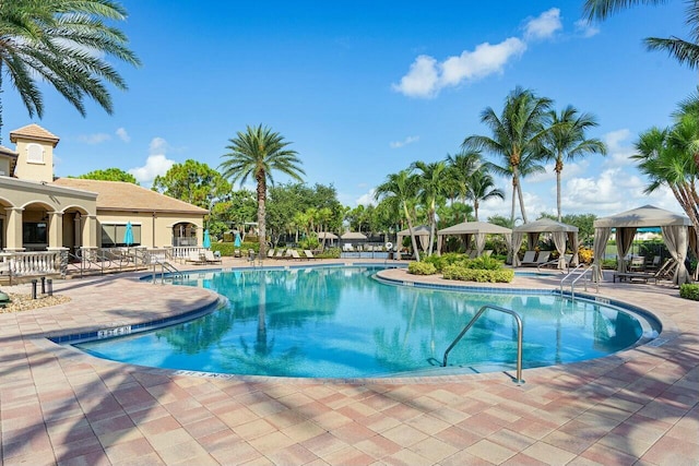 pool with a gazebo and a patio area