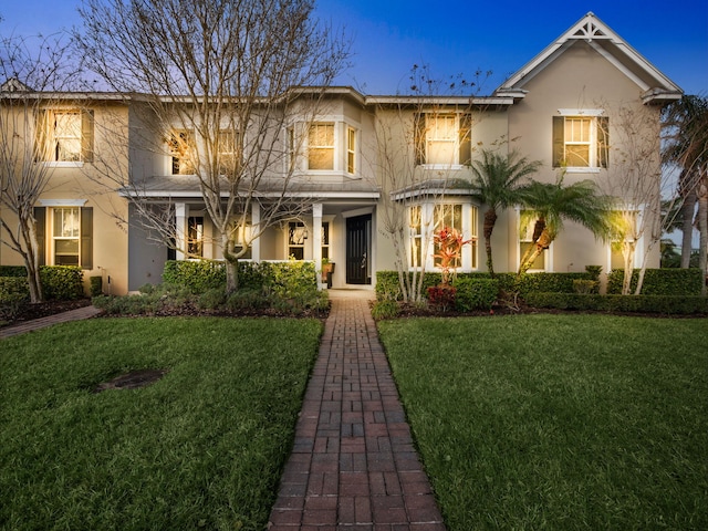 view of front of home with a lawn