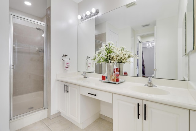 bathroom with tile patterned flooring, vanity, and walk in shower