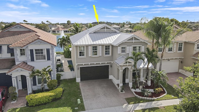 view of front of property featuring a garage and a front lawn