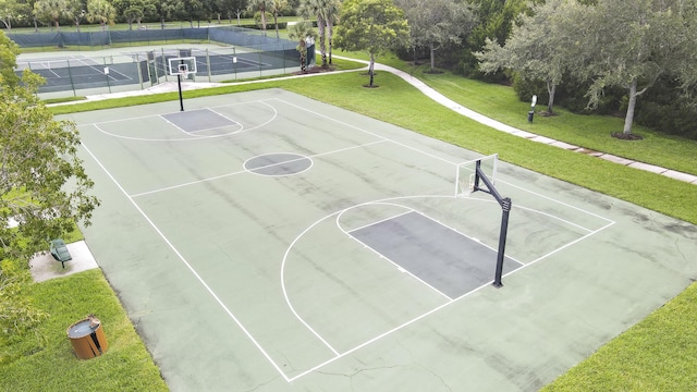 view of basketball court featuring a yard and tennis court